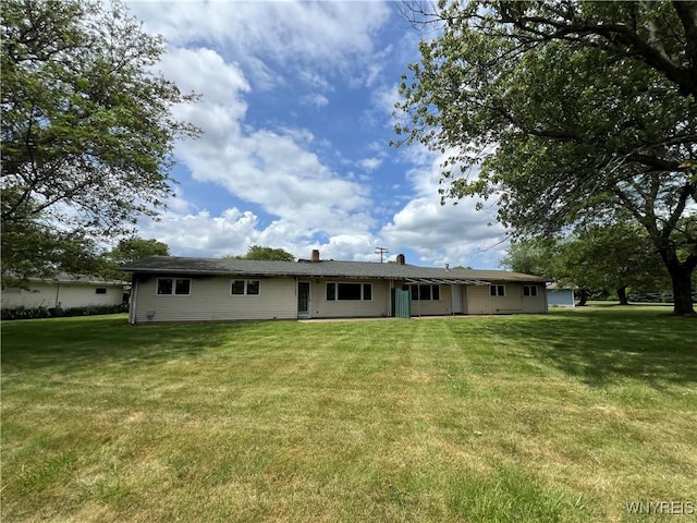 69 Steele Cir, Niagara, NY 14304 - back of house featuring a yard and a chimney