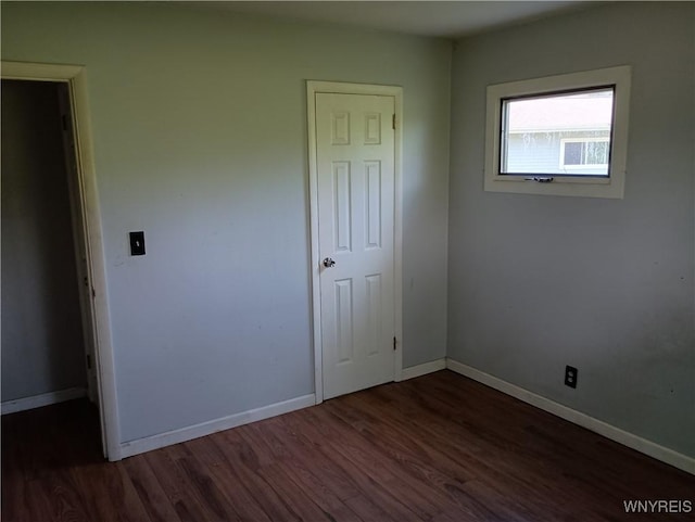 69 Steele Cir, Niagara, NY 14304 - unfurnished bedroom featuring dark wood-style floors and baseboards