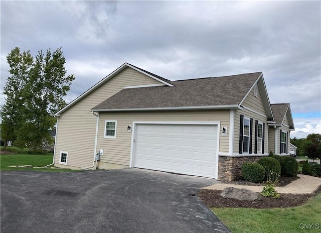 165 Shaker Hts, Camillus, NY 13031 - view of side of home with driveway, roof with shingles, a garage, and stone siding