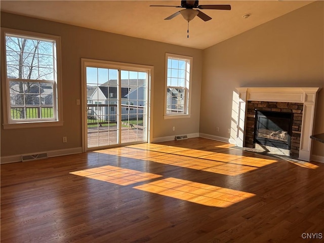 165 Shaker Hts, Camillus, NY 13031 - unfurnished living room featuring ceiling fan, wood finished floors, healthy amount of natural light, a fireplace, and lofted ceiling
