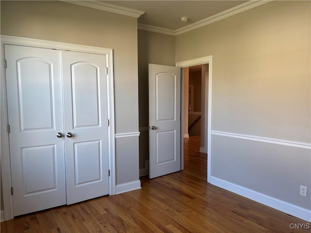165 Shaker Hts, Camillus, NY 13031 - unfurnished bedroom with wood finished floors, ornamental molding, and a closet