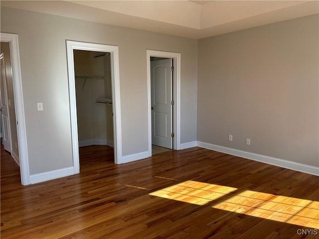 165 Shaker Hts, Camillus, NY 13031 - unfurnished bedroom with wood finished floors, a spacious closet, and a closet