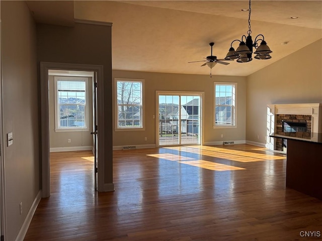 165 Shaker Hts, Camillus, NY 13031 - unfurnished living room featuring wood finished floors, healthy amount of natural light, a chandelier, a stone fireplace, and lofted ceiling
