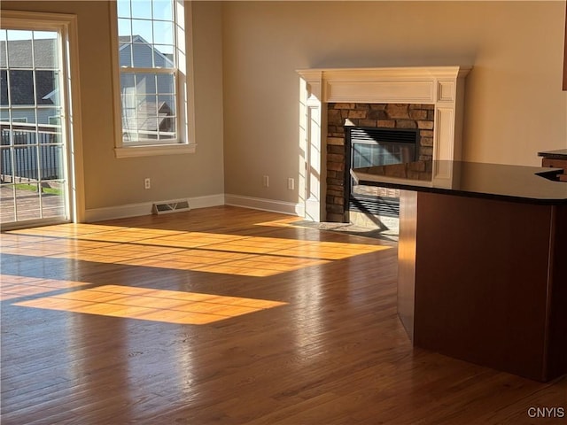 165 Shaker Hts, Camillus, NY 13031 - unfurnished living room with wood finished floors and a fireplace