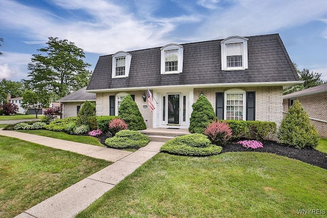 177 Foxpoint W, Amherst, NY 14221 - view of front facade featuring mansard roof, brick siding, roof with shingles, and a front yard