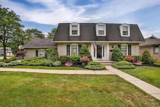 177 Foxpoint W, Amherst, NY 14221 - view of front of house with mansard roof, brick siding, a shingled roof, and a front lawn