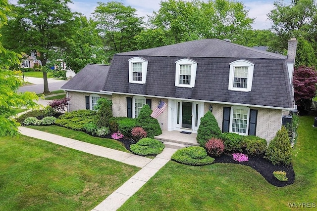 177 Foxpoint W, Amherst, NY 14221 - view of front of house with a shingled roof, brick siding, mansard roof, and a front lawn