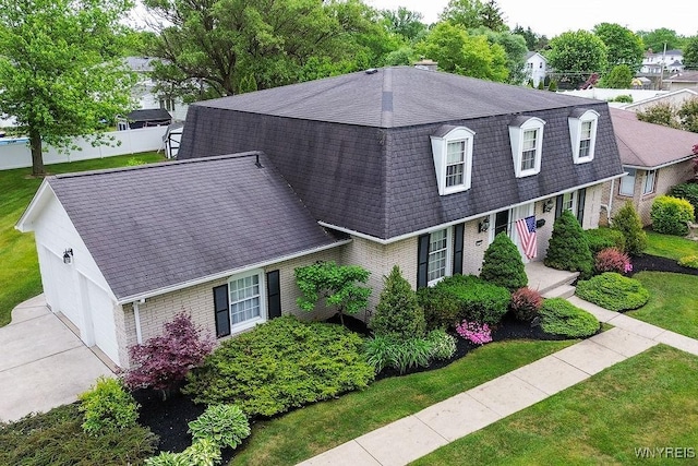 177 Foxpoint W, Amherst, NY 14221 - colonial inspired home featuring roof with shingles, brick siding, a garage, driveway, and a chimney