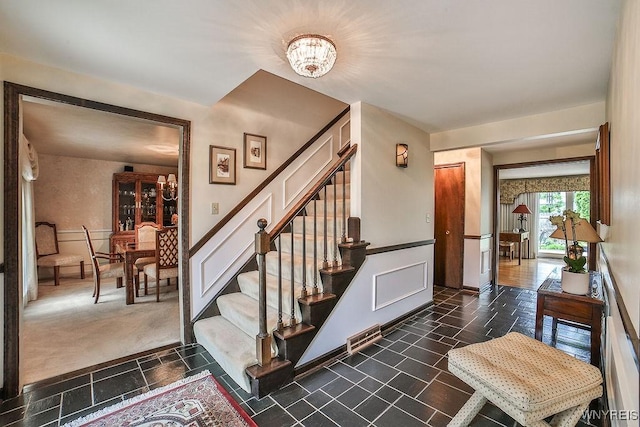 177 Foxpoint W, Amherst, NY 14221 - staircase featuring a chandelier