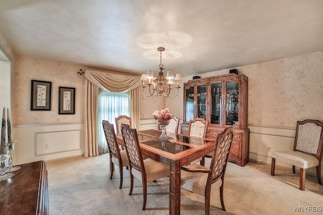 177 Foxpoint W, Amherst, NY 14221 - dining area featuring a chandelier, light colored carpet, wallpapered walls, and a wainscoted wall
