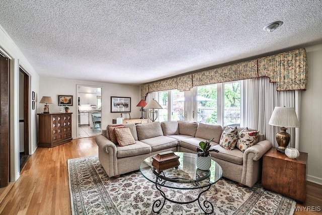 177 Foxpoint W, Amherst, NY 14221 - living area with a textured ceiling and light wood-type flooring