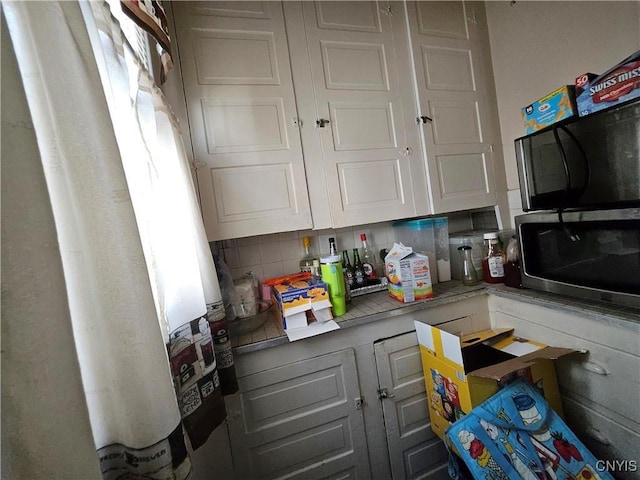 283 Genesee Park Dr, Syracuse, NY 13224 - kitchen featuring decorative backsplash, stainless steel microwave, and fridge