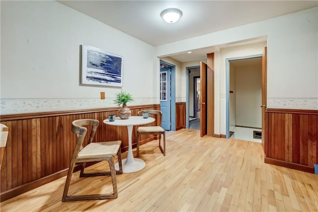 107 Fieldston Ter, Brighton, NY 14610 - dining area featuring wainscoting, light wood-type flooring, and wood walls