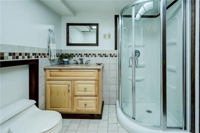 107 Fieldston Ter, Brighton, NY 14610 - bathroom with tile walls, tile patterned flooring, a shower stall, vanity, and a wainscoted wall