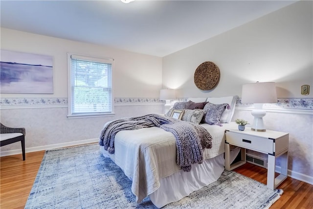 107 Fieldston Ter, Brighton, NY 14610 - bedroom featuring wood finished floors, wainscoting, and wallpapered walls
