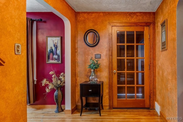 8652 Griffon Ave, Niagara Falls, NY 14304 - hall with wood finished floors, arched walkways, and a textured ceiling