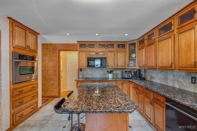 8652 Griffon Ave, Niagara Falls, NY 14304 - kitchen with black appliances, a kitchen bar, light tile patterned flooring, brown cabinetry, and recessed lighting