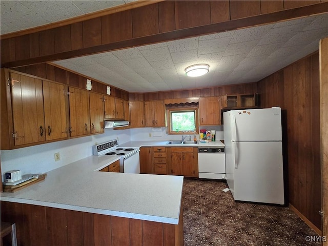 7412 State Highway 51, Plainfield, NY 13491 - kitchen with white appliances, wood walls, light countertops, exhaust hood, and brown cabinetry