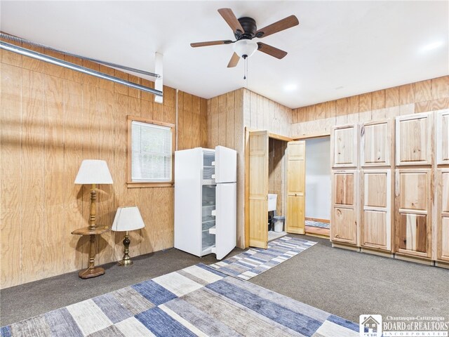 56 Heather Ln, Bradford, PA 16701 - bedroom with carpet, wooden walls, freestanding refrigerator, and ceiling fan