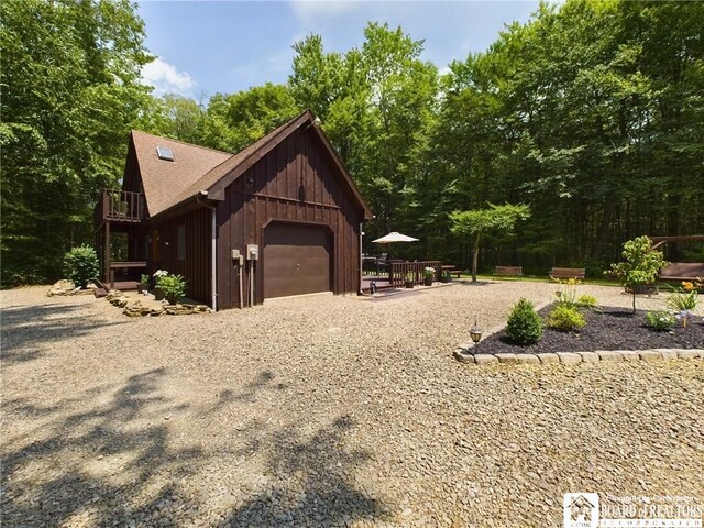 56 Heather Ln, Bradford, PA 16701 - view of home's exterior featuring gravel driveway, an attached garage, and a deck