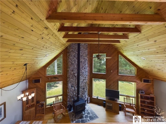 56 Heather Ln, Bradford, PA 16701 - living area with a wood stove, a wood ceiling with exposed beams, wood walls, light wood-style floors, and a chandelier