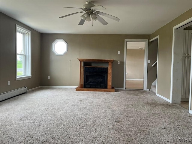 12853 Fuller Rd, Adams, NY 13606 - unfurnished living room featuring a ceiling fan, carpet, stairs, a fireplace with raised hearth, and baseboard heating