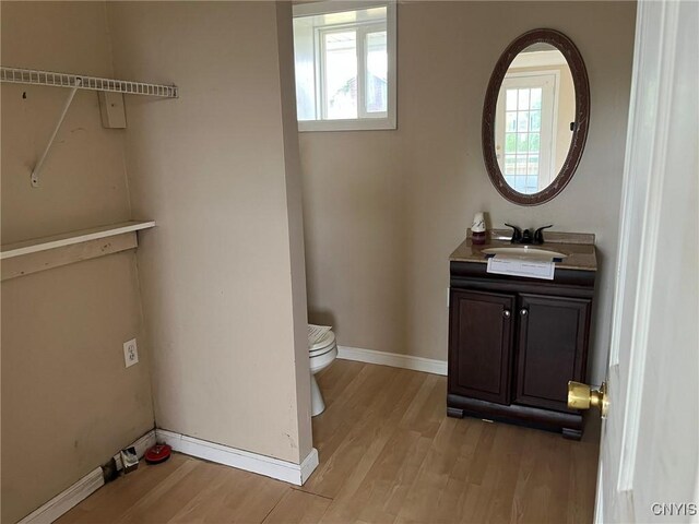12853 Fuller Rd, Adams, NY 13606 - half bathroom with vanity, wood finished floors, and healthy amount of natural light