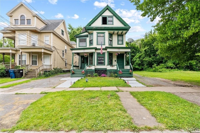905-07 Tallman St, Syracuse, NY 13204 - victorian-style house with a porch and a front lawn