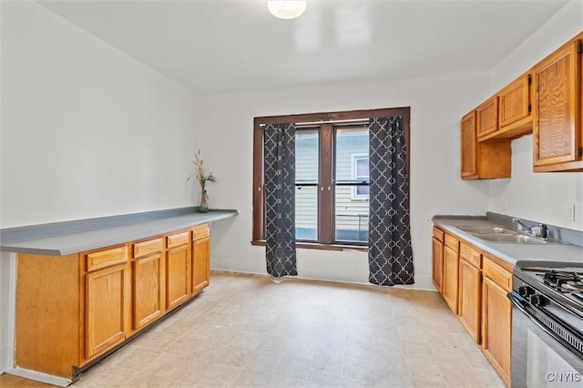 905-07 Tallman St, Syracuse, NY 13204 - kitchen featuring black gas range oven, light flooring, light countertops, and brown cabinetry