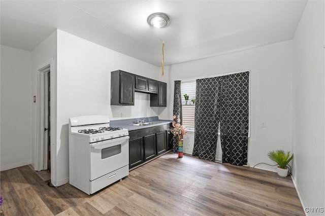 905-07 Tallman St, Syracuse, NY 13204 - kitchen with white range with gas stovetop, light wood finished floors, and light countertops