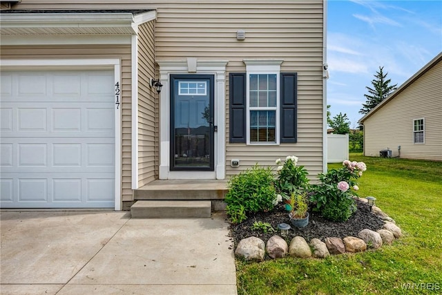 4217 Arthur Ct, Hamburg, NY 14075 - property entrance featuring a lawn, driveway, and an attached garage