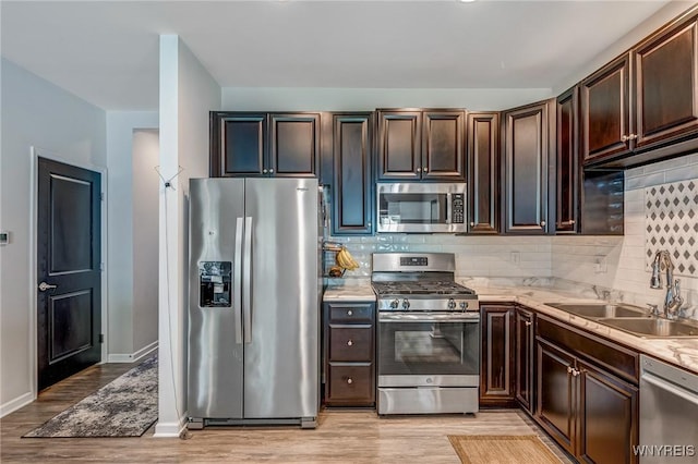 4217 Arthur Ct, Hamburg, NY 14075 - kitchen with stainless steel appliances, light wood-style flooring, backsplash, and light countertops