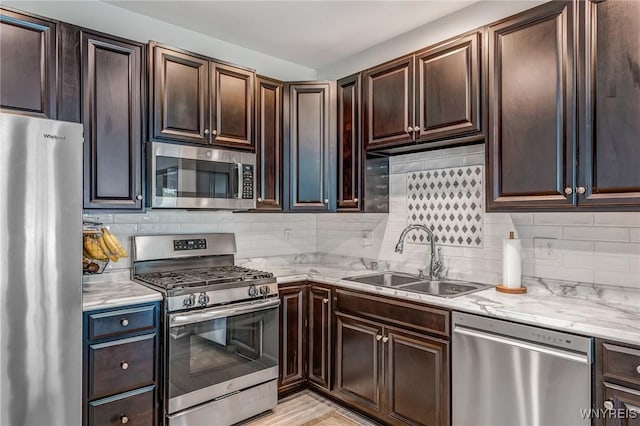 4217 Arthur Ct, Hamburg, NY 14075 - kitchen featuring stainless steel appliances, decorative backsplash, light stone countertops, and dark brown cabinetry