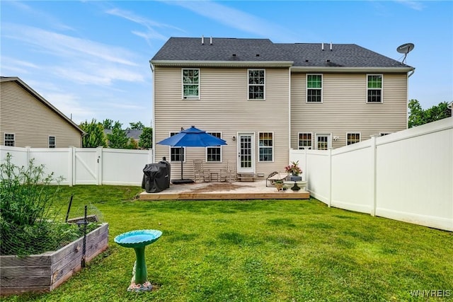 4217 Arthur Ct, Hamburg, NY 14075 - rear view of house with a vegetable garden, a fenced backyard, a deck, and a gate
