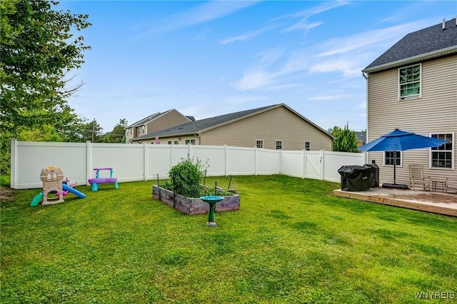 4217 Arthur Ct, Hamburg, NY 14075 - fenced backyard with a deck and a vegetable garden