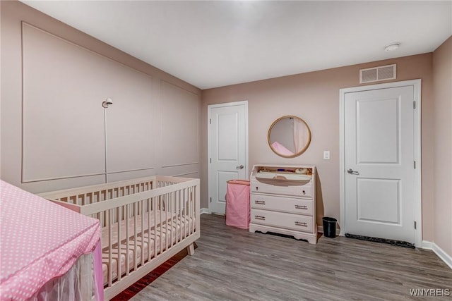 4217 Arthur Ct, Hamburg, NY 14075 - bedroom with wood finished floors and a nursery area