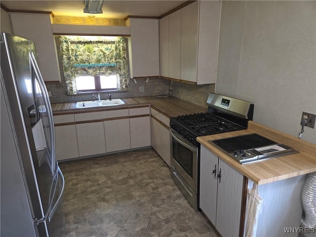 2595 Jerauld Ave, Niagara Falls, NY 14305 - kitchen featuring stainless steel appliances, tasteful backsplash, stone finish flooring, and white cabinets