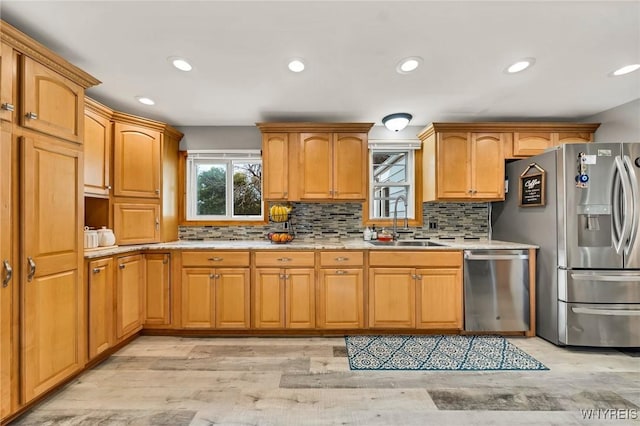 48 Meaford Rd, Cheektowaga, NY 14215 - kitchen featuring appliances with stainless steel finishes, backsplash, recessed lighting, light wood-type flooring, and light stone countertops