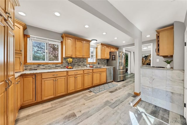 48 Meaford Rd, Cheektowaga, NY 14215 - kitchen with stainless steel appliances, light wood-style floors, recessed lighting, tasteful backsplash, and light stone counters