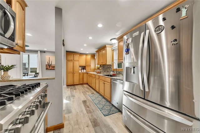 48 Meaford Rd, Cheektowaga, NY 14215 - kitchen with stainless steel appliances, light wood finished floors, recessed lighting, decorative backsplash, and light countertops