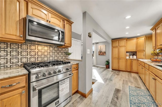 48 Meaford Rd, Cheektowaga, NY 14215 - kitchen with appliances with stainless steel finishes, backsplash, light wood-style flooring, recessed lighting, and light stone counters