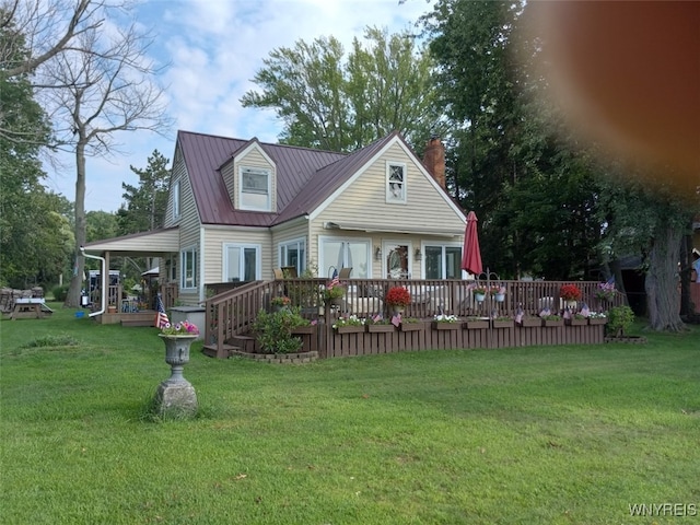 9802 Shorecliff Rd, Evans, NY 14006 - rear view of house featuring a wooden deck, a chimney, a lawn, and a metal roof