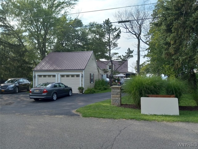 9802 Shorecliff Rd, Evans, NY 14006 - view of side of home with a garage and a metal roof