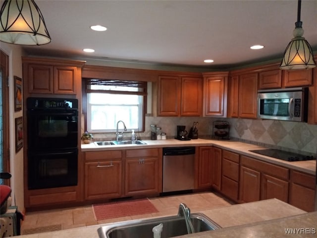 9802 Shorecliff Rd, Evans, NY 14006 - kitchen with black appliances, light countertops, backsplash, recessed lighting, and brown cabinets