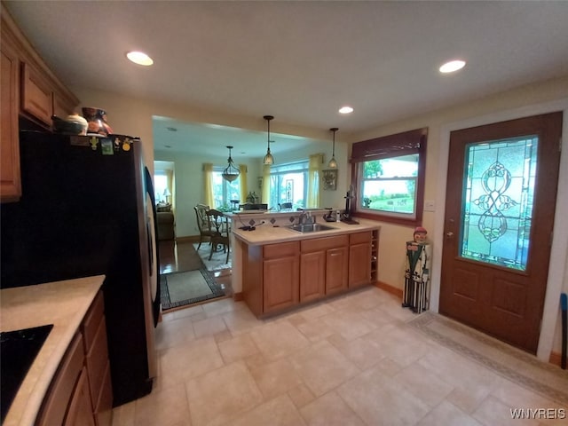 9802 Shorecliff Rd, Evans, NY 14006 - kitchen featuring freestanding refrigerator, light countertops, a peninsula, recessed lighting, and decorative light fixtures