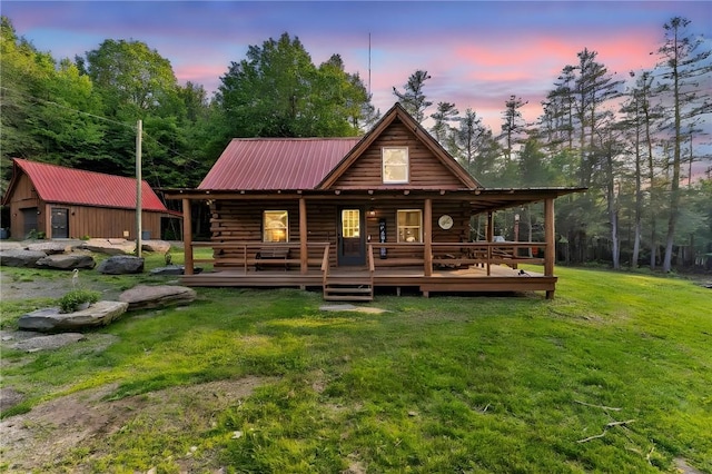 661 Lewis Rd, Meredith, NY 13806 - back of property at dusk with a lawn, a metal roof, and log exterior