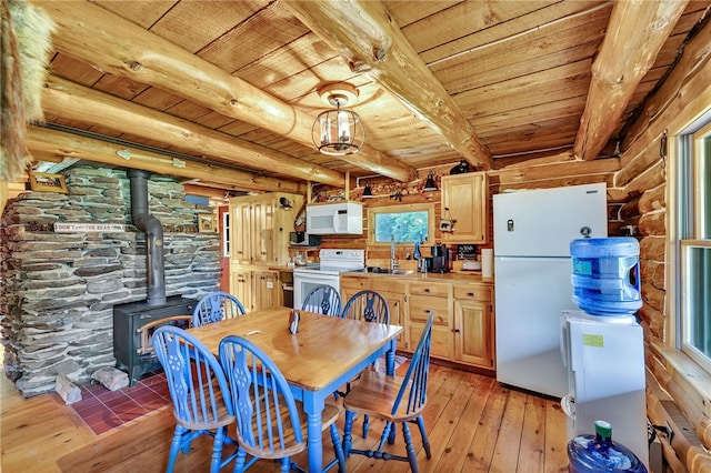 661 Lewis Rd, Meredith, NY 13806 - dining room featuring a wooden ceiling with exposed beams, light wood finished floors, a wood stove, rustic walls, and healthy amount of natural light
