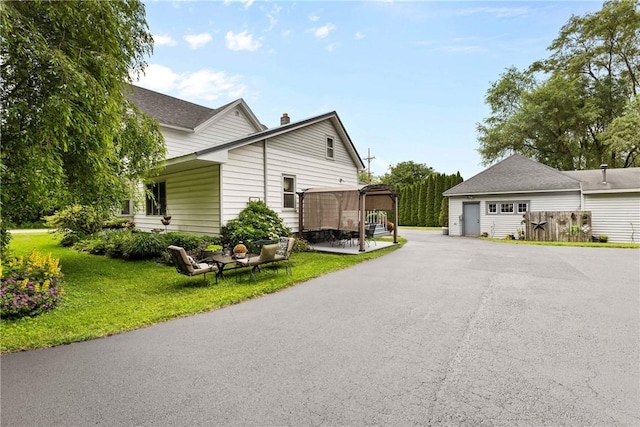 639 Plank Rd, Penfield, NY 14580 - view of side of property featuring a garage, a yard, and a chimney