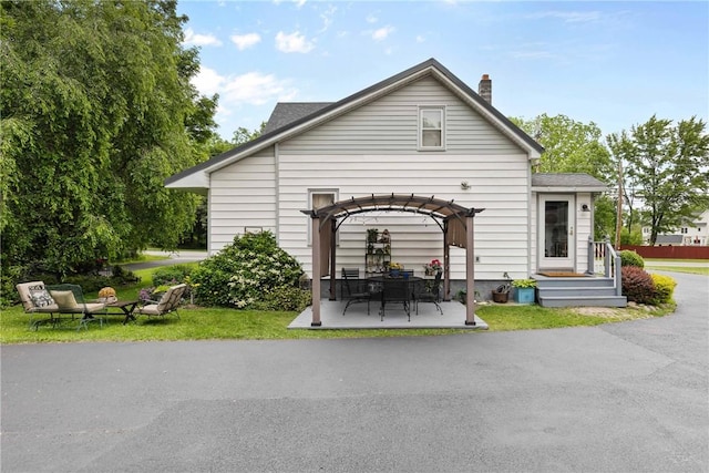 639 Plank Rd, Penfield, NY 14580 - rear view of property featuring a patio area, a pergola, and a chimney