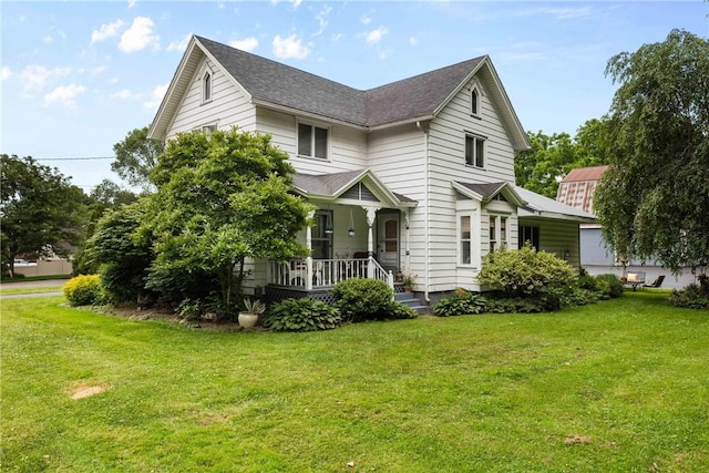 639 Plank Rd, Penfield, NY 14580 - view of front of house featuring a porch, a front lawn, and a shingled roof